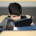 Santiago Uribegan, 9, of Farmington Hills, plays a game on his tablet during Michigan Robotics Day at the Jack Roth Stadium Club at Michigan Stadium on Monday, April 15, 2013. Melanie Maxwell I AnnArbor.com